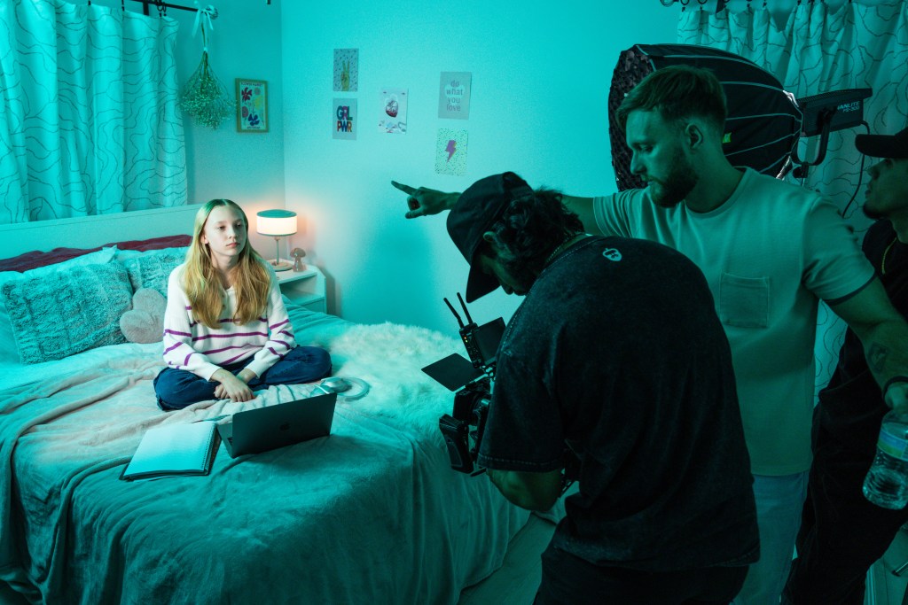 Videographer collaborating with a brand team on set